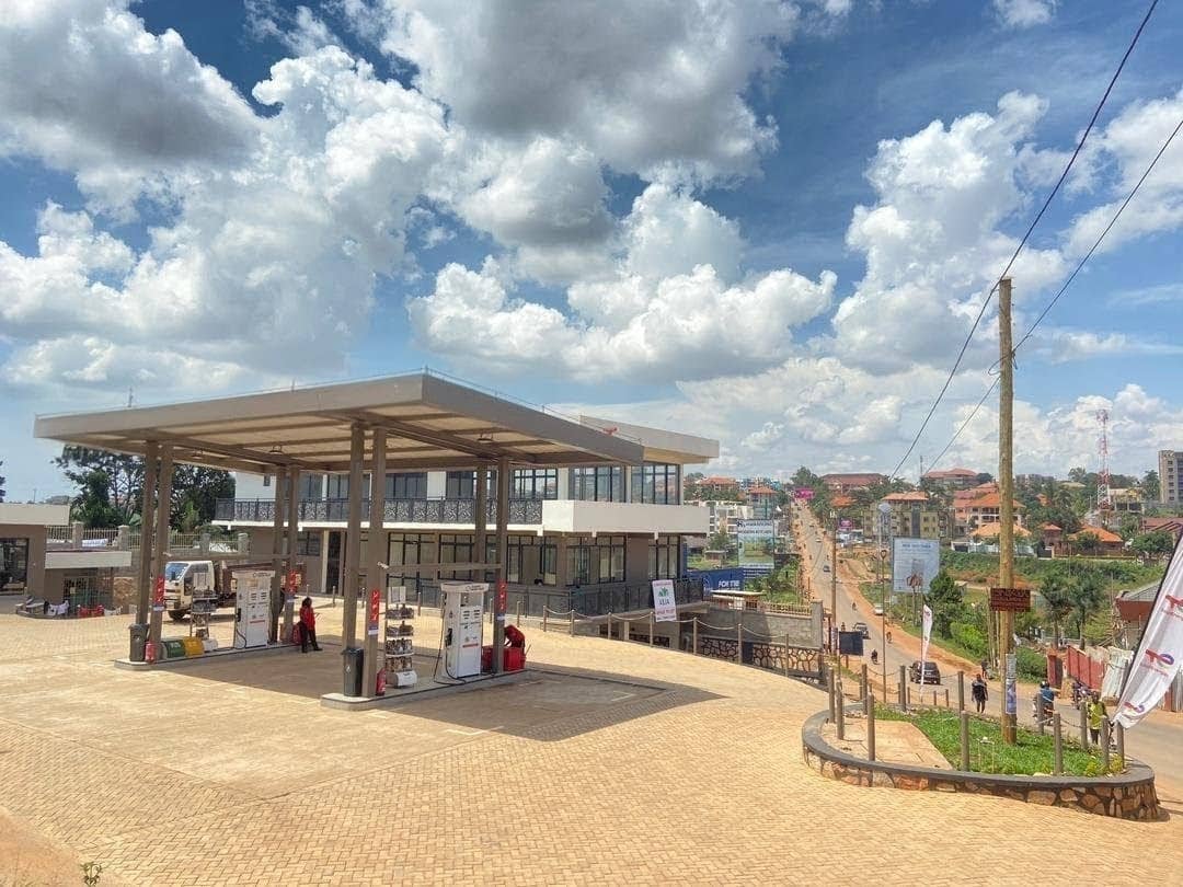 Team of fuel industry professionals discussing operations in modern office with digital screens